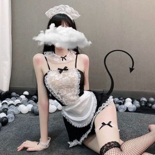 Woman in black and white sexy maid costume with lace apron, headband, and fishnet stockings for erotic role play.