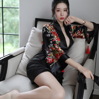 A woman poses elegantly in a black japanese anime-themed sheer kimono-inspired sleepwear set, featuring vibrant floral patter...