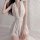 Woman wearing a white, sheer lingerie sleep dress with lace waistband and deep v-neckline. romantic bedroom wear for women.