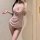 Woman wearing a pink sheer mesh halter sleep dress with draped neckline and gold chain accents, highlighting a flirty silhoue...