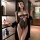 Woman modeling black lace bodysuit and robe in modern bedroom. seductive womens lingerie set for intimate moments.
