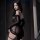 Woman wearing black sheer luxury sensual lingerie set for couples, elegant playful sleepwear with no-remove design.
