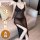 Woman wearing black sheer mesh night soup plus size lingerie with deep v neckline and long slip design, seated on sofa.