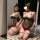 Woman kneeling in mirror wearing seductive polka dot bodysuit with open-crotch design, fishnet stockings, and cat ears.