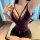 Woman wearing purple lace lingerie set with deep v-neck bra and matching panties, curvy fit for plus size.