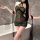Woman wearing green night silk lace cheongsam lingerie set in bathroom, sheer mesh with floral print and long black sleeves.
