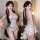 Woman modeling floral lace low-cut cami and bodycon sleep dress set with sheer mesh details and ribbon ties.
