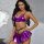 Woman wearing purple metallic lingerie set with black thong, featuring bralette and pleated skirt.