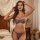 Woman modeling french lace sexy lingerie set with sheer mesh bra and thong, featuring underwire support and adjustable ties.