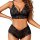 Woman wearing black lace lingerie set with open-crotch design and bow details – sheer, sexy two-piece outfit.