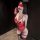 Woman wearing qingshe sexy lingerie – red lace bodysuit with sheer stockings, blindfold, and gag in dimly lit room.