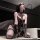 Model wearing chaomu embroidered lingerie set, a black sheer bodysuit with lace detailing and strappy accents.