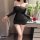 Woman wearing black fei niao moon gaze bodycon dress, holding red rose beside vase of white flowers.