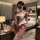 Woman in pink pure & playful lingerie set, cute student-style open-crotch bodysuit with hook closure and sheer ruffles.