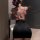Woman wearing sheer floral lace bodysuit with black skirt, back view of halter neck lingerie set.