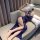 Woman in navy lace lingerie set with feather mask, reclining on sofa. modest yet seductive nightwear with elegant straps and ...