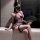 Woman in sexy vintage lace cheongsam lingerie with sheer see-through fabric, holding black fan, wearing fishnet stockings.