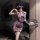 Woman modeling purple lace cheongsam lingerie set with sheer panels, garter straps, and black bow detail, holding a fan.