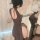 Woman wearing reversible high-waist split cheongsam lingerie set, back view showing seductive design for bedroom romance.