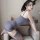 Woman wearing gray pure & playful lingerie set, seductive secretary-style sleepwear, posing on beige sofa for romantic nights...