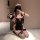 Woman in black and pink maid costume with paw gloves, kneeling on white rug. pure & playful lingerie set for role play.