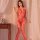Woman wearing red plus size lace fishnet bodystocking with tear-away crotch, sheer mesh lingerie in bedroom setting.