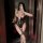 Woman in purple lace bodysuit with adjustable straps, holding wine glass and phone, showcasing sexy moonbird-inspired sleepwe...