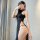 A woman poses in a black sheer babydoll with a sensual split design, embodying pure temptation style. perfect for sleepwear, ...