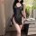 A woman poses elegantly in a black lace night silk dress inspired by chinese cheongsam design, featuring frog buttons and hig...
