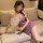 A woman elegantly poses on a couch wearing a seductive chinese-style purple lace cheongsam slip dress. the sheer floral disc ...