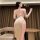 A woman models the plus size pure temptation lingerie dress, featuring a backless design with lace sleeves and a high slit, p...
