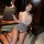 Woman in pure & seductive secretary style lace lingerie set with pencil skirt, holding clipboard, posing elegantly on office ...