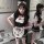 A woman models a cute anime cat girl lolita cosplay outfit, featuring a maid costume with black and white accents, bows, and ...