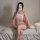A woman poses with a phone, wearing a delicate pink embroidered lingerie set featuring a qipao-style design, perfect for an e...