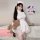 A person wearing a white nurse costume set, featuring lace details, high-slit design, and summer-ready white mesh fabric, hol...