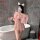 A woman poses in a bathroom wearing a pink sheer lace sleep dress with an open-crotch design, holding a glass of champagne wh...