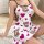 A woman wears a white satin sleep dress adorned with pink hearts and brown teddy bears, ideal for summer lounging.
