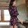A woman stands by a mirror wearing a sheer chiffon kimono robe adorned with pink lips patterns, ideal for women seeking elega...