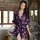 A woman models a sheer chiffon kimono robe adorned with pink butterfly patterns, featuring a deep v-neckline and tie waist, p...