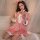 A woman wears a pink velvet christmas-themed sleepwear set, featuring a cute bow headband and matching robe, perfect for fest...