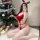 A woman poses in a festive setting wearing a red christmas-themed bodysuit with faux fur accents, perfect for holiday celebra...