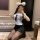 Woman kneeling in mirror selfie wearing pure & playful lingerie set – sheer white top, black skirt, cat ears, sensual qqny st...