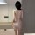 Woman wearing sparkling sequin cross-back bodysuit with deep v-neck and lace detailing, shown from behind in elegant indoor s...