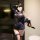 Woman in navy lace lingerie set with fishnets, holding red-soled heels—sensual, playful, no-remove uniform style.