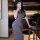 A woman poses in a stylish gray bodycon dress, highlighting its form-fitting design and elegant simplicity. the dress feature...