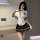 A woman poses wearing an airusu sexy student uniform lingerie set, featuring a plunging white blouse with a tie, paired with ...