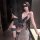 Woman in black lace bodysuit with floral details, sheer stockings, and a mask, holding a wand—chaomu lace temptation lingerie...