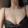 Woman wearing a gold cherry blossom body chain with crystals, styled as a sexy chest necklace over black lingerie.