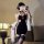A woman poses in a black chinese-style sexy lingerie dress featuring high slits, a backless halter design, and embroidery, pe...