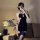A woman poses with a fan, wearing a black chinese-style sexy lingerie dress featuring high slits, backless halter neck, and e...